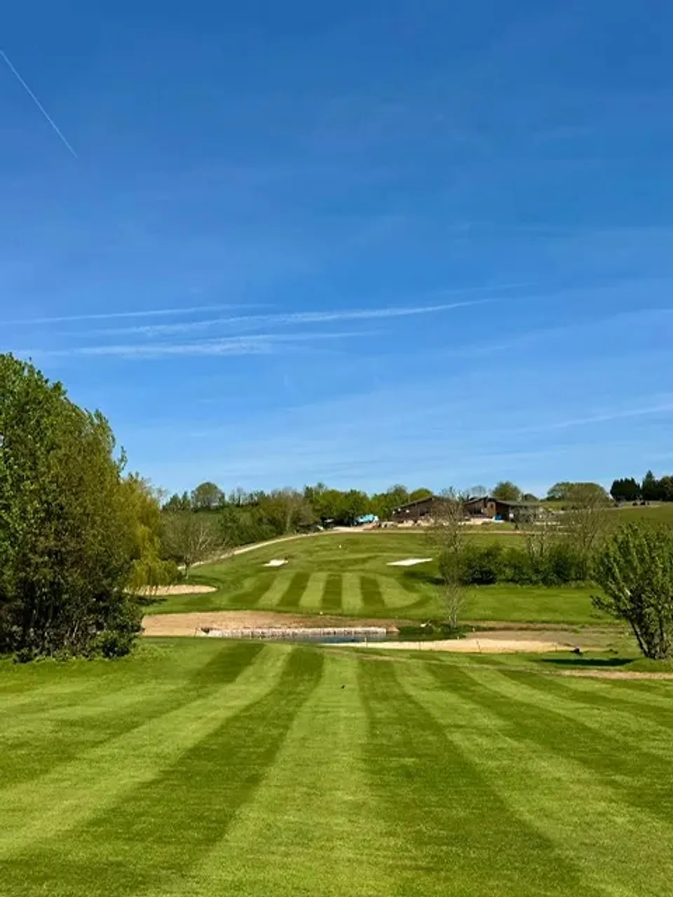 Parkland fairway framed by Devon hills at Exminster