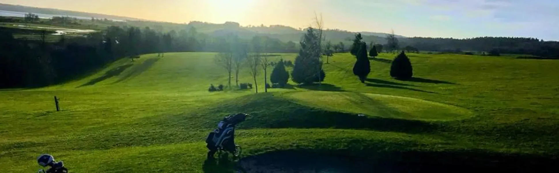 Golden-hour light across a fairway at Exminster Golf Centre